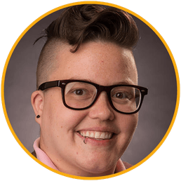 Keynote speaker Dr. Kirsten LaMantia, counselor educator, smiling in a studio portrait wearing glasses and a pink collared shirt.